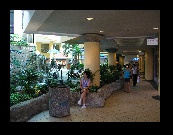 Angie's found a place in the mall with a breeze and is trying to cool off. The mall is not air conditioned although most stores are.